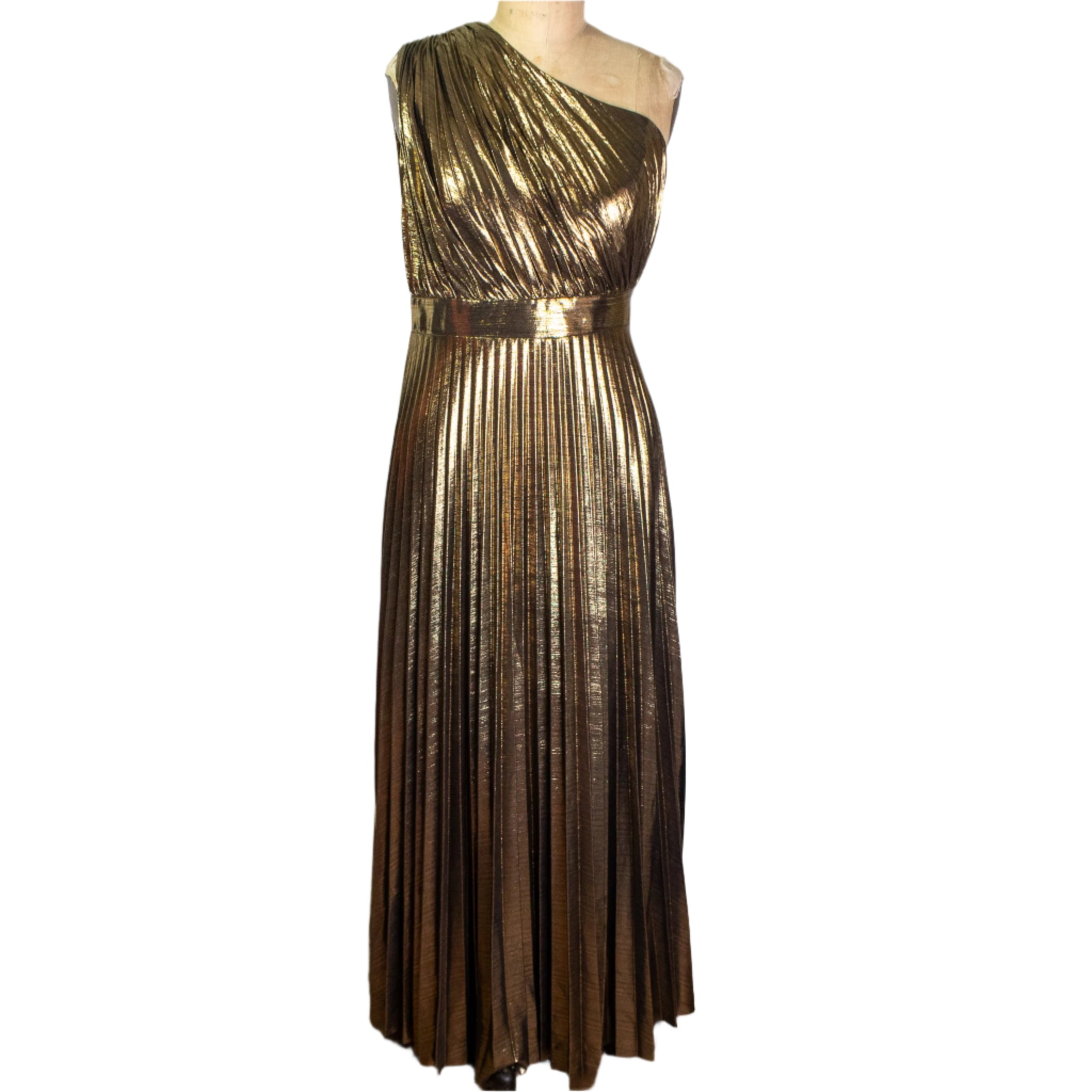 Gold one-shoulder dress on a mannequin against a white curtain in a storage room.