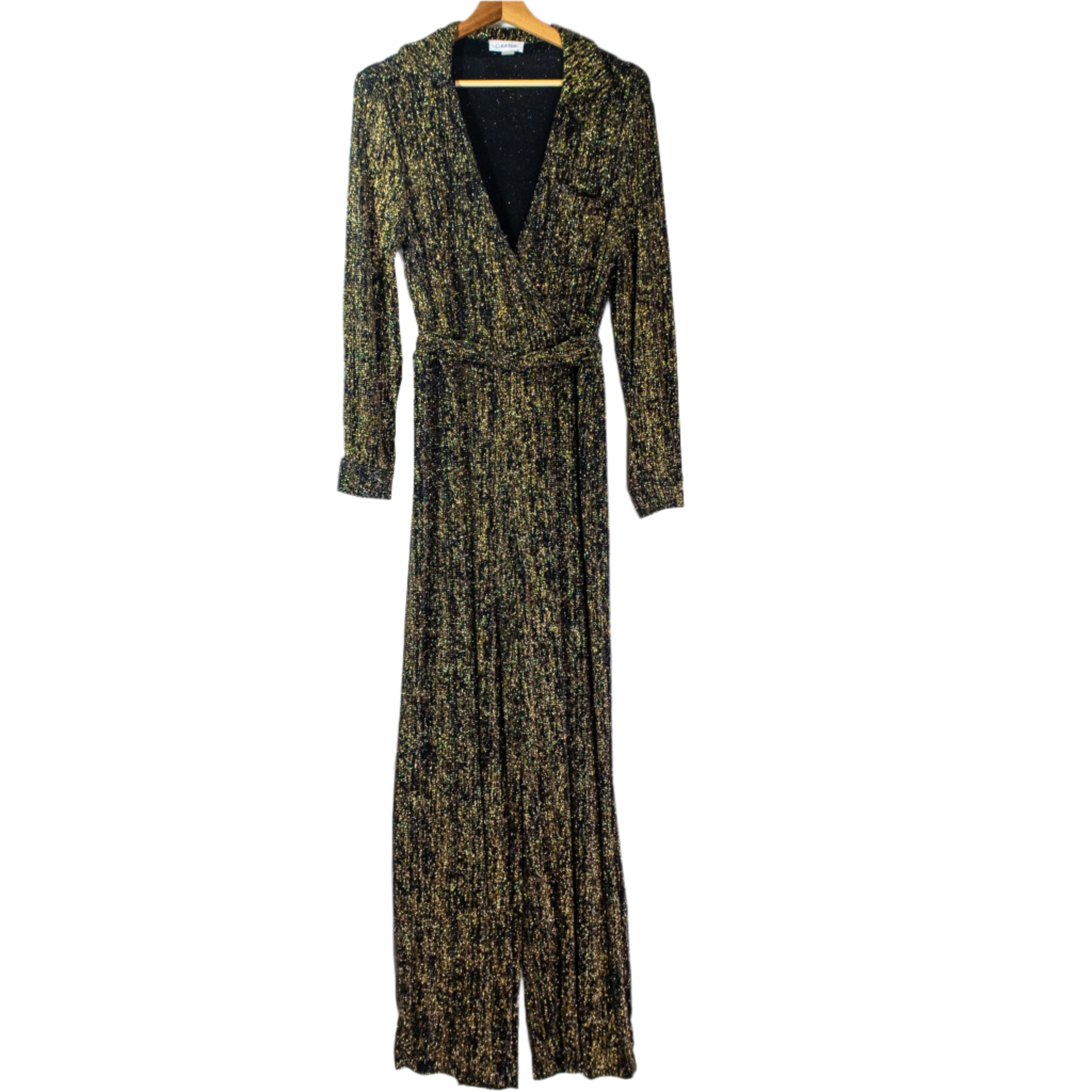 Long-sleeve dress with a pattern on a hanger against a white curtain.