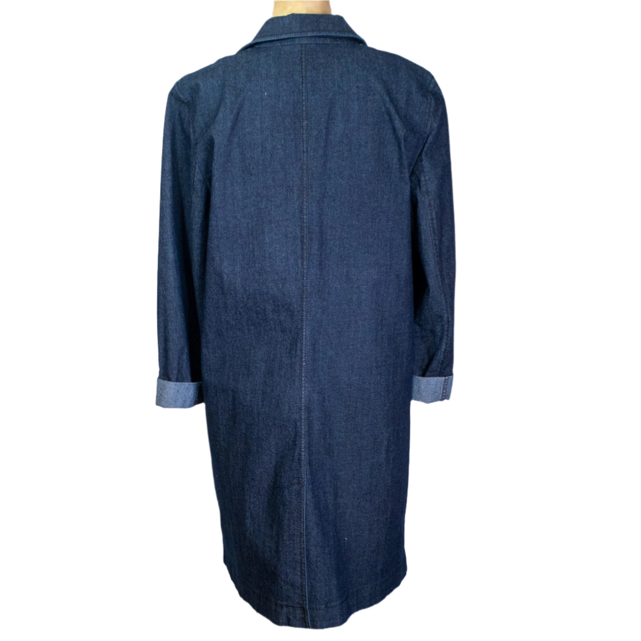 Blue denim coat on a mannequin against a white curtain background